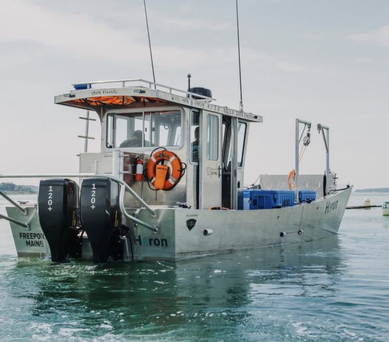 Maine Ocean Farm's electric boat on calm waters powered by Evoy electric outboard motor